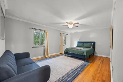 a living room with a couch and a bed at Heated, Cozy 3BR Perfect for Winter Getaways in Columbus