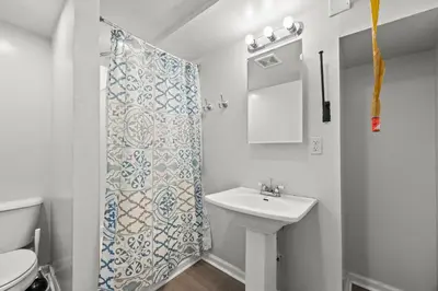 a bathroom with a sink and a shower curtain at Heated, Cozy 3BR Perfect for Winter Getaways in Columbus