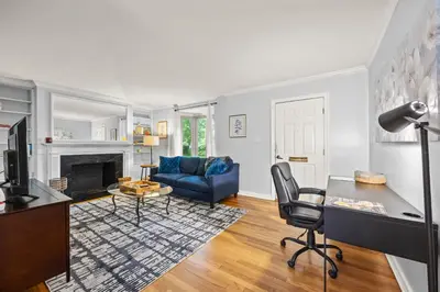 a living room with a blue couch and a table at Heated, Cozy 3BR Perfect for Winter Getaways in Columbus