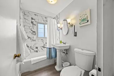 a bathroom with a toilet and a sink and a shower at Heated, Cozy 3BR Perfect for Winter Getaways in Columbus