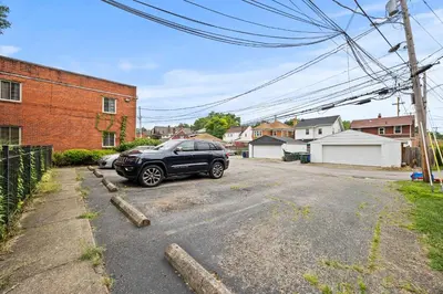 a black car parked in a parking lot at Heated, Cozy 3BR Perfect for Winter Getaways in Columbus