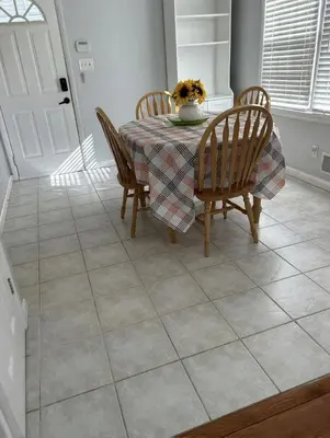 a dining room with a table and chairs with a vase on it at Relaxing 4BR Holiday Retreat Large, Cozy & Close to Airport in Columbus