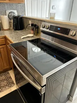 a kitchen with a stove top oven in a kitchen at Relaxing 4BR Holiday Retreat Large, Cozy & Close to Airport in Columbus