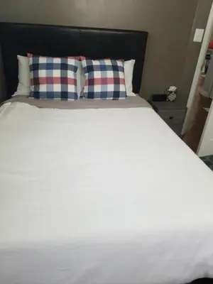 a white bed with two pillows on top of it at Relaxing 4BR Holiday Retreat Large, Cozy & Close to Airport in Columbus