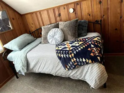 a bed in the corner of a room at Relaxing 4BR Holiday Retreat Large, Cozy & Close to Airport in Columbus