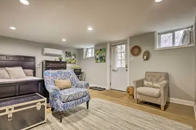 a bedroom with a bed and a chair and a couch at Northern Kentucky Studio Near Cincinnati! in Southgate
