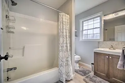 a bathroom with a shower and a toilet and a sink at Renovated Logan Home with Pond and Fire Pit in Logan