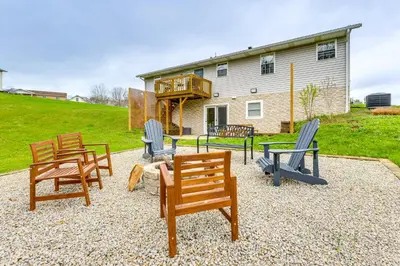 a group of chairs and tables in front of a house at Renovated Logan Home with Pond and Fire Pit in Logan