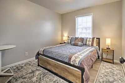 a bedroom with a bed and a window at Renovated Logan Home with Pond and Fire Pit in Logan