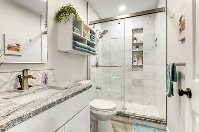 a white bathroom with a toilet and a shower at Renovated Logan Home with Pond and Fire Pit in Logan