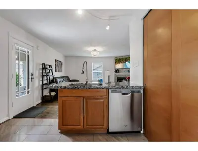a kitchen with a sink and a dishwasher at Housepitality - Little River Trails in Mason