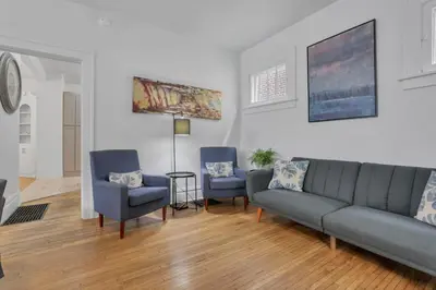 a living room with a couch and two chairs at Housepitality - The Maynard Manor in Columbus