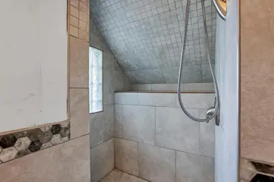 a bathroom with a shower with a shower head at Housepitality - The Maynard Manor in Columbus