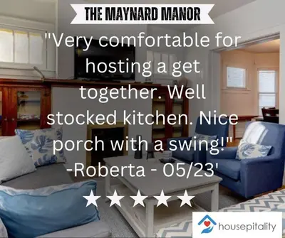 a living room with a couch and a table at Housepitality - The Maynard Manor in Columbus