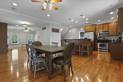 a kitchen and dining room with a table and chairs at Housepitality - The Victorian Vacation Home in Columbus