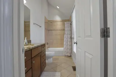 a bathroom with a tub and a toilet and a sink at Housepitality - The Victorian Vacation Home in Columbus