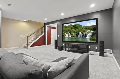 a living room with a couch and a flat screen tv at Housepitality - The Victorian Vacation Home in Columbus