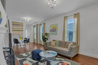 a living room with a couch and a table at Housepitality - The Columbus Game House - 2 BR in Columbus