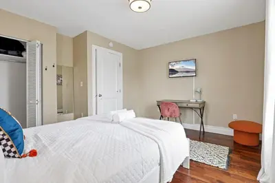 a bedroom with a white bed and a desk at Housepitality - The Columbus Game House - 2 BR in Columbus