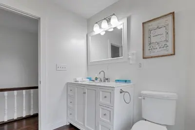 a white bathroom with a sink and a toilet at Housepitality - The Columbus Game House - 2 BR in Columbus