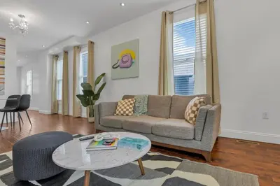 a living room with a couch and a table at Housepitality - The Columbus Game House - 2 BR in Columbus
