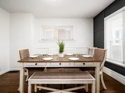 a dining room with a wooden table and chairs at Large 5 Bedroom House Next to OSU, Sleeps 16 in Columbus