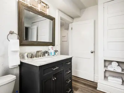a bathroom with a sink and a mirror at Large 5 Bedroom House Next to OSU, Sleeps 16 in Columbus