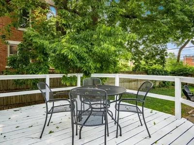 a black table and chairs on a deck at Large 5 Bedroom House Next to OSU, Sleeps 16 in Columbus
