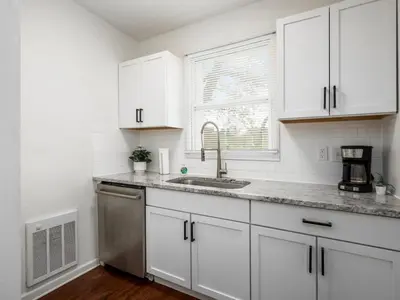 a kitchen with white cabinets and a sink at Large 5 Bedroom House Next to OSU, Sleeps 16 in Columbus