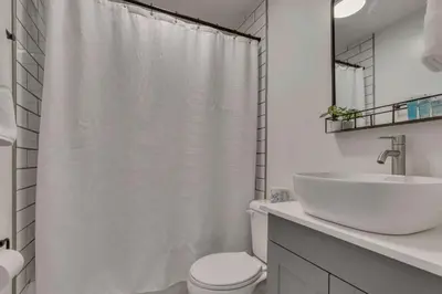 a white bathroom with a sink and a toilet at Housepitality - The Southside Ranch in Columbus