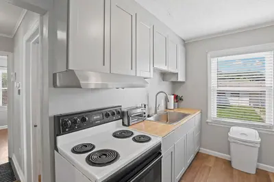 a kitchen with a stove and a sink at Housepitality- The Bungalow -2 BR in Columbus
