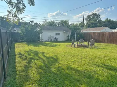 a yard with a fence and a backyard with a house at Housepitality- The Bungalow -2 BR in Columbus