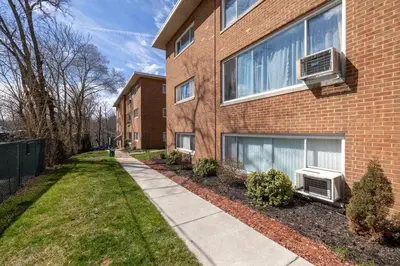 a building with two air conditioners on the side of it at Georgetown Villas Two Bedroom 3-2a Apartment in Fairview Park, Ohio! in Fairview Park