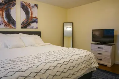 a bedroom with a bed and a flat screen tv at 4BR/2.5BA Home boasting 2400sqft and Eat-in KTN in Toledo