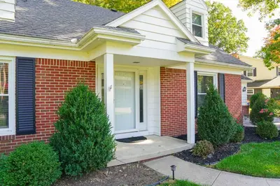 a house with a front porch and two trees at 4BR/2.5BA Home boasting 2400sqft and Eat-in KTN in Toledo