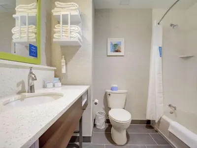 a bathroom with a toilet and a sink and a tub at Hampton Inn & Suites Williamstown Ark Encounter, Ky in Williamstown