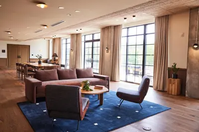 a living room with a couch and chairs and a table at The Junto Hotel in Columbus