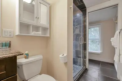 a bathroom with a toilet and a glass shower at OSU and Short North 4 Bedroom Patio and Garage with EV in Columbus