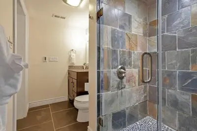 a bathroom with a toilet and a glass shower at OSU and Short North 4 Bedroom Patio and Garage with EV in Columbus