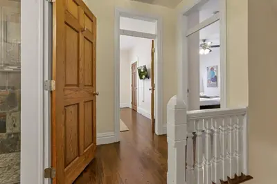 a hallway with a wooden door and a hallway with a room at OSU and Short North 4 Bedroom Patio and Garage with EV in Columbus