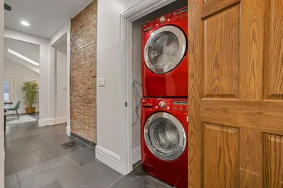 a red washer and dryer in a hallway at OSU and Short North 4 Bedroom Patio and Garage with EV in Columbus