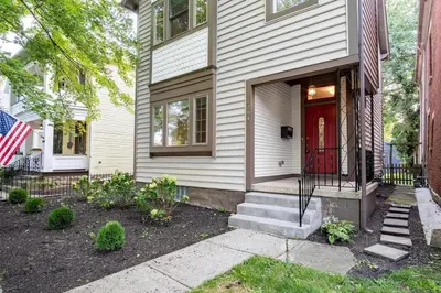 a house with a red door and an american flag at OSU and Short North 4 Bedroom Patio and Garage with EV in Columbus