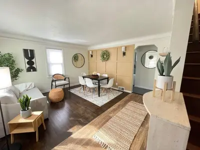 a living room with a couch and a table at New! Cozy 4-bedroom w/ free parking. Dogs welcome! in Berea