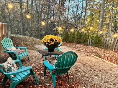 three chairs and a table with a vase of flowers at New! Cozy 4-bedroom w/ free parking. Dogs welcome! in Berea