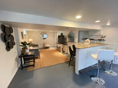 a large living room with a kitchen and a living room at New! Cozy 4-bedroom w/ free parking. Dogs welcome! in Berea