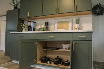 a kitchen with green cabinets with pots and pans at New 1-bedroom Bungalow! 4 miles to CLE in Berea