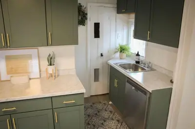 a kitchen with green cabinets and a sink at New 1-bedroom Bungalow! 4 miles to CLE in Berea