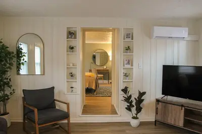 a living room with a television and a mirror at New 1-bedroom Bungalow! 4 miles to CLE in Berea