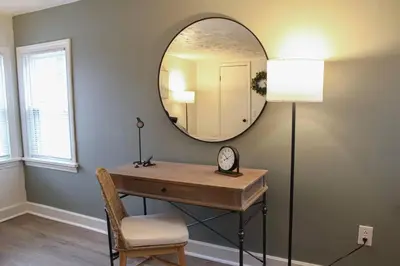 a room with a mirror and a desk with a clock at New 1-bedroom Bungalow! 4 miles to CLE in Berea