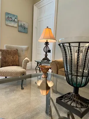 a living room with a glass table and a lamp at Extended Stays by Lee House Inn in Maysville